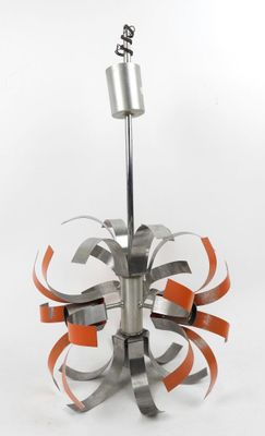 an image of a metal sculpture with orange ribbons on it