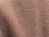 brown sweater with holes in the middle of it