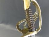 a gold colored sword with a metal handle on a table