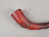a pipe that is sitting on a table next to a wall