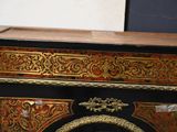 a black and gold cabinet with a clock on it