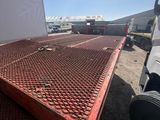 a flatbed truck that is parked in a lot
