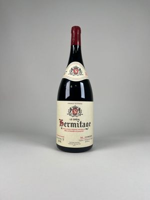 a bottle of red wine sitting on top of a table