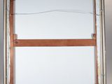 an easel with a wooden frame and a white canvas on it