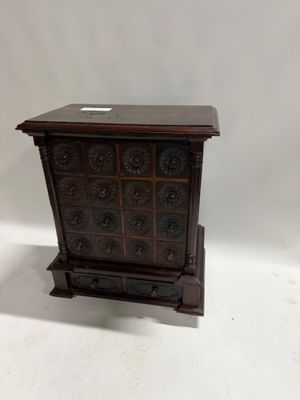 an image of a small wooden chest of drawers on a white background
