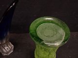 two glass vases sitting next to each other on a table