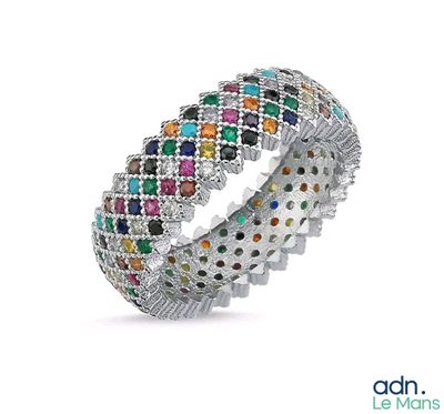 a close up of a multi colored diamond ring on a white background