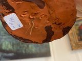 a person holding a piece of chocolate cake with a sticker on it