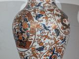 a vase that is sitting on top of a wooden stand