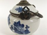 a small blue and white vase with a bird on it