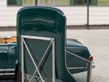 a green chair that is next to a green car