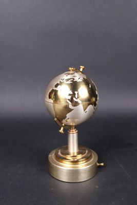 an image of a gold and silver globe on a metal stand