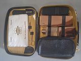 a black and gold case with a cell phone inside of it