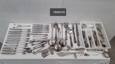 a lot of silverware in a tray on a table