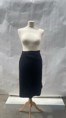 the mannequin is standing on a wooden stand in front of a white backdrop