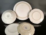 several plates and bowls are sitting on a black surface