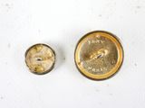 two buttons that are sitting on a white surface