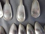 six spoons and two spoon spoons on a table