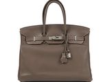 a brown leather handbag on a white background