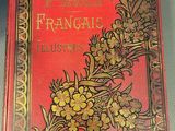 an old red book with gold flowers on it sitting on a table
