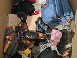a cardboard box filled with clothes and shoes