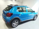 a picture of a blue dacia parked in a garage