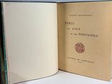 a book opened to show a picture of paris and its fountains
