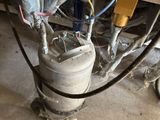 a man standing next to a keg with a hose attached to it