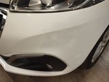 a close up of a car ' s headlight and front bumper