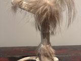 a sculpture of a bird that is sitting on top of a table