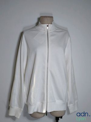 the white jacket is on a mannequin stand on a mannequin stand
