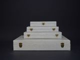 three white suitcases stacked on top of each other