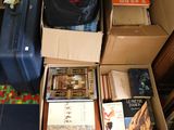 many suitcases and books on the floor in a room