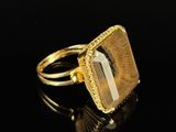 a close up of a gold ring with a stone on it