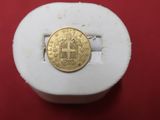 an image of a gold coin sitting on top of a white box
