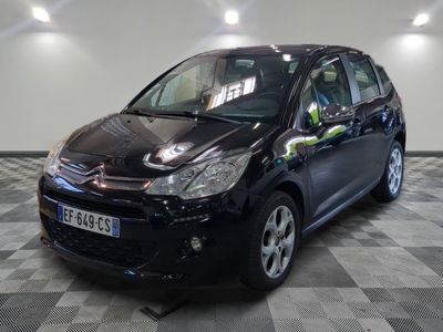 a picture of a small black car parked in a garage