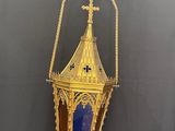 brass and blue glass lantern hanging from a rope