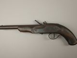 an old gun that is on display on a table