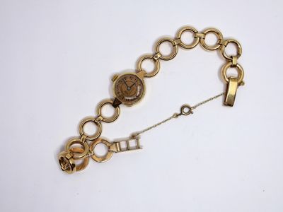 an image of a gold bracelet with a clock on it