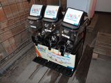 trois distributeurs de sodas posés sur une table en bois