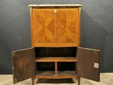 a wooden cabinet with two doors open on top of a wooden floor