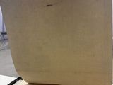 a person holding a piece of paper on top of a table