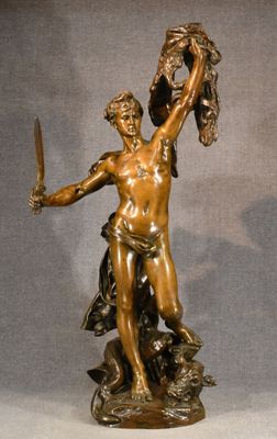 bronze statue of a man holding a sword and a shield