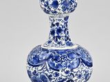 vase bleu et blanc orné d'un motif floral sur la base