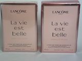 two boxes of lancomie la vie belle perfume on a white surface