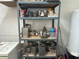 a small kitchen with a lot of clutter on the shelves