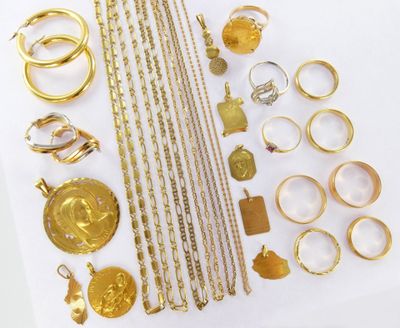 a lot of gold jewelry on a white surface