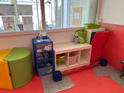 a room with a window, a shelf, and a chair in it