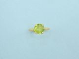 a yellow gold ring with a peridot stone in the center