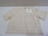 cream crocheted sweater with long sleeves and a button closure